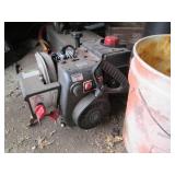 Contents of corner including buckets, a wood barrel, tar paper, motor and more