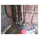 Contents of corner including buckets, a wood barrel, tar paper, motor and more