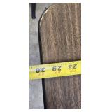 Stylish table with a wood-like surface and metal legs, measuring 59.5 x 30 inches.