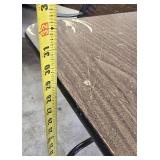 Stylish black table with a sturdy wood-like surface and chic metal legs, measuring 59.5 x 30 inches.