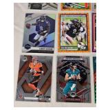 Lot of 24 Inserts and Relic Football Cards Featuring Players Like Lamar Jackson, Justin Herbert, and Trevor Lawrence. Includes Rookie Cards and Special Inserts. Lot of 24 Inserts and Relic Football Cards Featuring Players Like Lamar Jackson, Justin Herbert, and Trevor Lawrence. Includes Rookie Cards and Special Inserts.