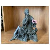 Bronze-colored seated woman figure... Bronze-colored seated woman figure...