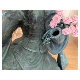 Bronze-colored seated woman figure... Bronze-colored seated woman figure...