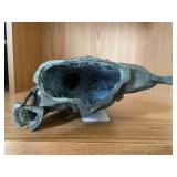 Bronze-colored seated woman figure... Bronze-colored seated woman figure...