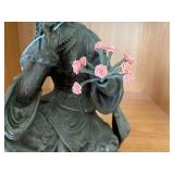 Bronze-colored seated woman figure... Bronze-colored seated woman figure...