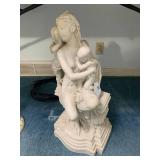 Woman seated tending to a child, 14... Woman seated tending to a child, 14...