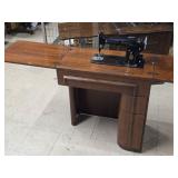 Singer Sewing Machine with Wood Flip-Top Cabinet 58' x 17' x 38' Singer Sewing Machine with Wood Flip-Top Cabinet 58' x 17' x 38'