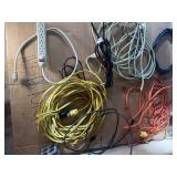 collection of various electrical extension cords and a power strip