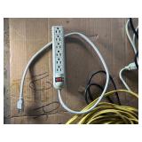 collection of various electrical extension cords and a power strip