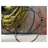 collection of various electrical extension cords and a power strip