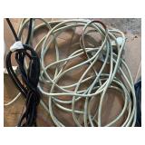 collection of various electrical extension cords and a power strip