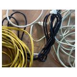 collection of various electrical extension cords and a power strip