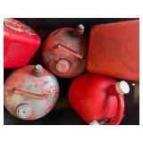 Lot of various gas cans including bucket.