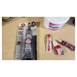 Various Opened and Used Automotive Fluids and Adhesives Including Liquid Wrench Lubricating Oil, PB Blaster Penetrating Catalyst, and Gojo Hand Cleaner