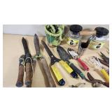 Various Garden Tools and Accessories including Trimmer Line, Shears, and Garden Hose