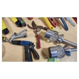 Various Garden Tools and Accessories including Trimmer Line, Shears, and Garden Hose