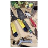 Various Garden Tools and Accessories including Trimmer Line, Shears, and Garden Hose