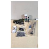 Gun cleaning supplies including Ballistol, Break-Free CLP, rods, and patches, plus assorted hardware pieces and tools