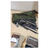 Gun cleaning supplies including Ballistol, Break-Free CLP, rods, and patches, plus assorted hardware pieces and tools