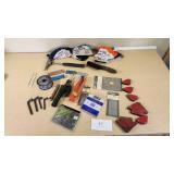 Various Welding Tools and Accessories including Magnetic Holders, Flint Lighter, and Welding Lenses