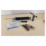 Lot of Hand Tools and Hardware Items including Grease Guns, Hooks, Chains, and Hinges