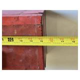 Red metal toolbox with assorted hand tools and accessories including pliers, screwdrivers, a utility knife, and a socket set