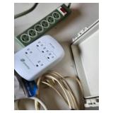 Assorted Electrical Components including APC Surge Protector, Power Strips, Extension Cords, and NEMA Enclosure