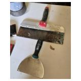 Drywall Tools and Supplies including Rolls of Tape, Trowels, and Sanding Tools