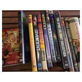 Collection of DVDs and CDs including Divergent, Spider-Man 2, and Christmas with Daniel