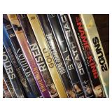 Collection of DVDs and CDs including Divergent, Spider-Man 2, and Christmas with Daniel
