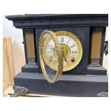 antique E. Ingraham Co. mantel clock, likely featuring a black ebonized wood case.