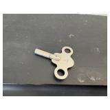 antique E. Ingraham Co. mantel clock, likely featuring a black ebonized wood case.