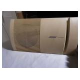 Vintage Bose speaker set with briefcase filled with cassette tapes