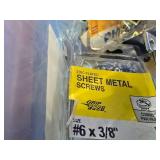 Bin of Assorted Hardware, Nuts, Bolts Hinges Etc. and Pack of 65 Watt Bulbs