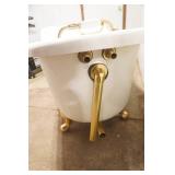 Fiberglass Slipper Clawfoot bathtub featuring polished gold-toned feet and brass hardware.