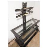 TV Stand. black metal frame, tempered glass shelves, integrated swivel mount for flat screen TV. 50"x 21"x 52"