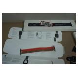 Asssortment of Apple Watch Bands and Charger