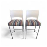 Steelcase Move bar stools featuring a white plastic back, a striped upholstered seat, and a four-leg metal frame. Steelcase Move bar stools featuring a white plastic back, a striped upholstered seat, and a four-leg metal frame.