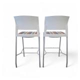 Steelcase Move bar stools featuring a white plastic back, a striped upholstered seat, and a four-leg metal frame. Steelcase Move bar stools featuring a white plastic back, a striped upholstered seat, and a four-leg metal frame.