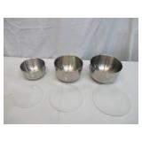 Assorted vintage stainless steel mixing bowls. Some with covers.
