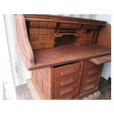 Antique rolltop desk with lots of s...