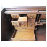 Antique rolltop desk with lots of s...