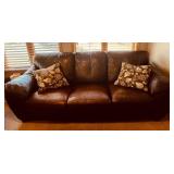 Brown Leather Sofa - 3-Seater with Floral Throw Pillows