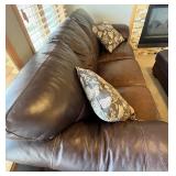 Brown Leather Sofa - 3-Seater with Floral Throw Pillows