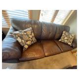 Brown Leather Sofa - 3-Seater with Floral Throw Pillows