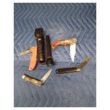 4 Pocket knives and a flashlight with case