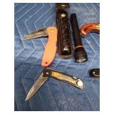 4 Pocket knives and a flashlight with case