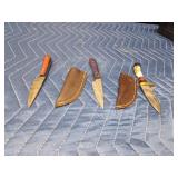 3 Handmade Damascus steel knives with Pakkawood handles and a stag antler handle knife. All with sheaths