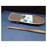 Skateboard and a wood baseball bat