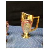 Gold and rose colored pitcher and 6 glasses